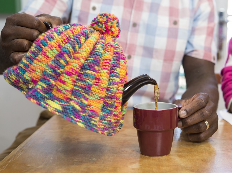 Teapot in knitted tea cosy